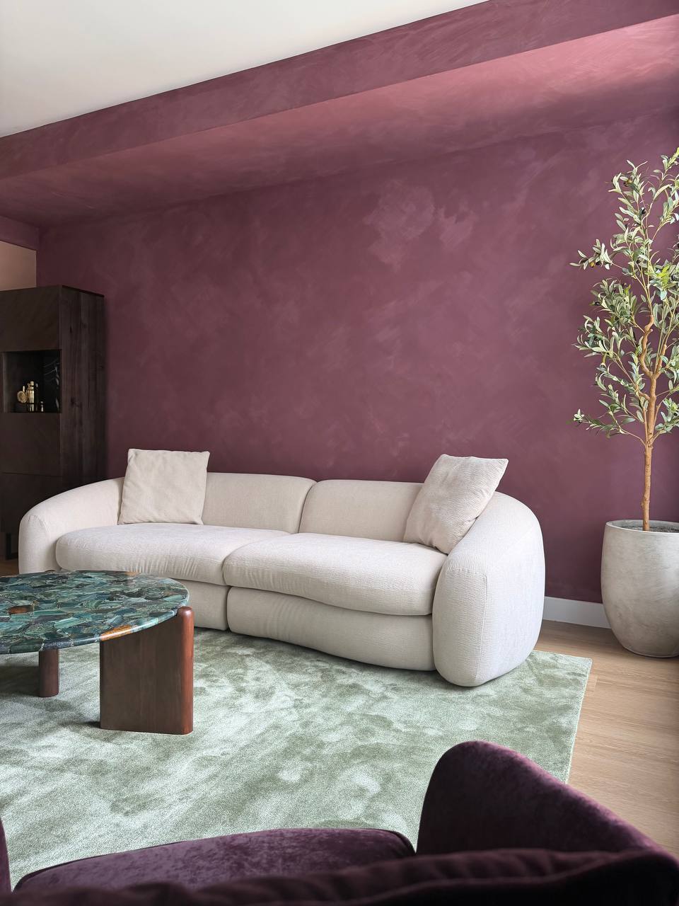 Plum limewash accent wall in a Los Angeles living room by Faberwurk